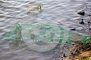 Fish tank on the river bank in the water