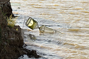 Fish tank in the water on the river bank