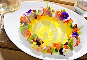 Fish tartare with fruits, vegetables, flowers in shape of ring