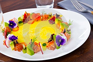 Fish tartare with fruits, vegetables, flowers in shape of ring