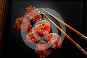 fish tartare sushi served nicely on a black plate