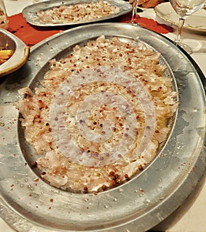 Fish tatare with pink pepper, Italian traditional dish of Chrismast eve, Italian food