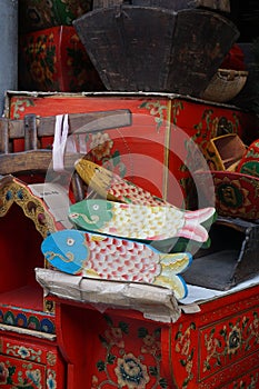 Fish and wooden souvenirs in a flea market in Beijing China