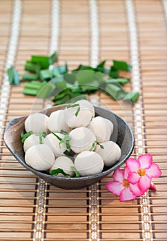 Fishballs in bowl on the bamboo floor.