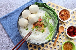 Fishballs rice noodle soup, Fishballs Bee Hoon noodle soup at top view with some sauce - Asian food