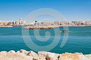 Fishboat enters the port of VIlamoura town in Portugal photo