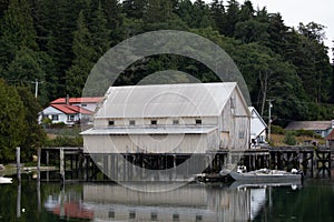 Fishboat wharf and shed with reflection in water at Sointula, Malcolm Island