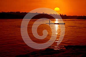 Fisher boat in the river with sunset