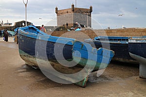 Fisher boats and bastion Borj El Barmil in port of Essouira