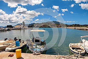 Fisher boats at The Panagia Vlacherna church with a nice cloudscape in Corfu, Greece