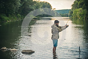 Fisher fishing equipment. Handsome man relaxing. Leisure on lake. Set up rod with hook line sinker. Bearded fisher in