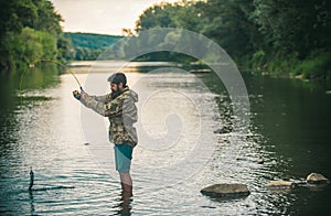 Fisher fishing equipment. Handsome man relaxing. Leisure on lake. Set up rod with hook line sinker. Bearded fisher in