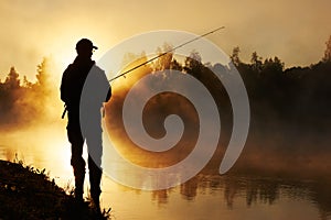 Fisher fishing on foggy sunrise