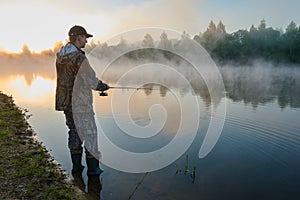 Fisher fishing on foggy sunrise