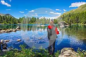 Fisher girl in an alpine lake