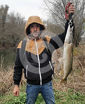 Fisher holding a big pike