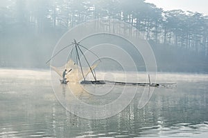 Fisher man fish out on the lake the tool of the fisher man, they using this one for thier job, in the foggy