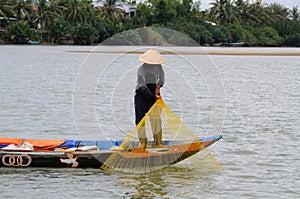 Fisher pulling up his net with his catch