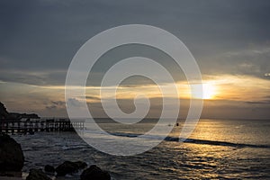 Fisherboat in horizon on sunset at sea in Bali, Indonesia