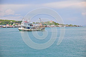 Fisheries boat and village scene along the coastal area