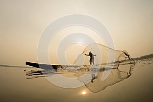 Fisherman action on the boat fishingnet.