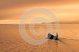 Fisherman alone on his boat