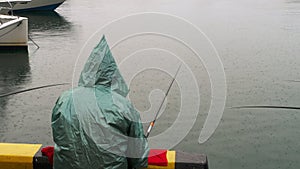 Fisherman angling in the rain.