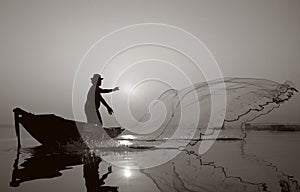 Fisherman of Bangpra Lake in action when fishing.(Sepia Style)