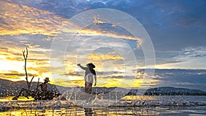 Fisherman of Bangpra Lake in action when fishing in the sunshine morning