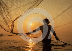 Fisherman of Bangpra Lake in action when fishing, Thailand