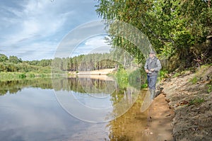 Fisherman on the bank of a beautiful river