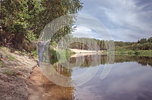 Fisherman on the bank of a beautiful river