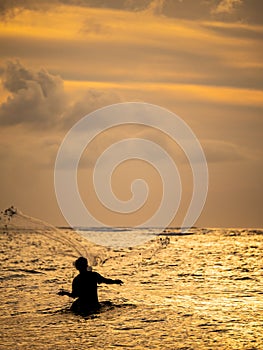 Fisherman on the beach at sunset in Bali
