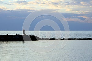 Fisherman in the beautiful sunset light, Tyrrhenian sea, Italy