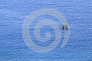 A fisherman in the blue sea