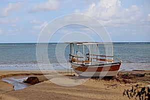 Fisherman boat anchored over beach sand