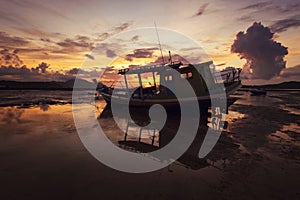 Fisherman boat in a beautiful view on the sea at sunrise