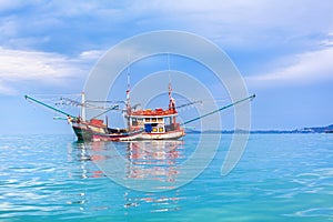 Fisherman boat on blue sea, sky, clouds landscape background close up, beautiful seascape with red wooden fishing vessel, Thailand