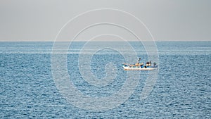 Fisherman in a boat fishing in the early morning. Mediterranean Sea