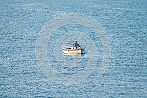 Fisherman in a boat fishing in the early morning. Mediterranean Sea