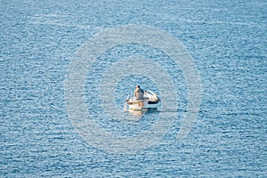 Fisherman in a boat fishing in the early morning. Mediterranean Sea