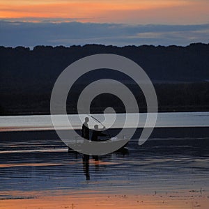 Fisherman, boat, fishing rod, over lake, France, Sunset