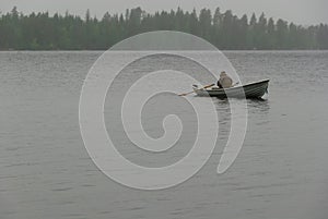 Fisherman boat fog rain