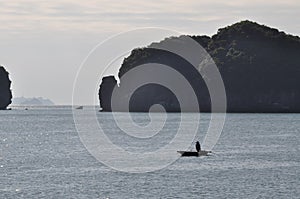 Fisherman in a boat in Ha Long Bay, Vietnam