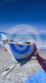 Fisherman Boat loads Fishing Net with Blue Sky and Cloudy Background