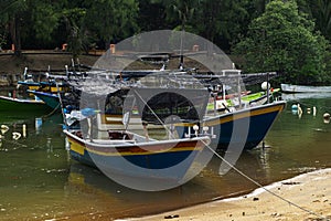 Fisherman boat moored near the sea shore