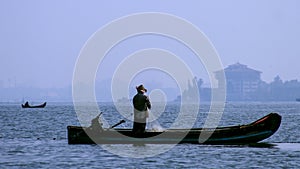 Fisherman in a boat. Photo from Cochin, Kerala in India