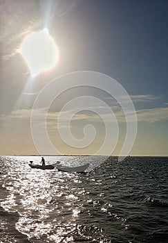 Fisherman boat in the sea at dusk.