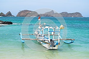 Fisherman boat with view of hills and turquoise ocean in Wedi Ireng beach, Banyuwangi