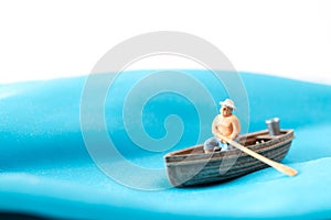 Fisherman in a boat on the waves, World Water Day concept